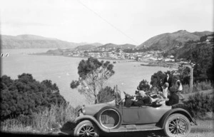 Group of people, and their car, overlooking Seatoun