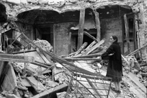 Woman clearing wreckage left by German troops in the village of Gessopalena, Italy