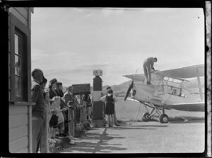 Otago Aero Club, people watching the refuelling of a Tiger Moth at Taieri Aerodrome