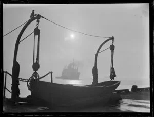 Unidentified ship sailing toward a wharf with a lifeboat, Auckland