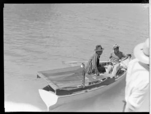Two men in a rowing boat with a bed frame, cream launch trip, Bay of Islands