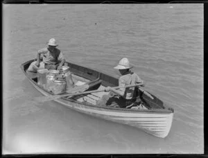 Two men in a rowing boat with milk containers, cream launch trip, Bay of Islands