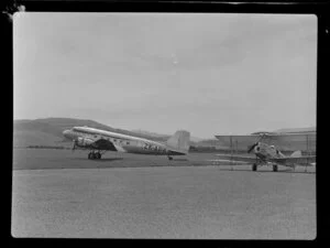 New Zealand National Airways Corporation DC3 Dakota ZK-APK, with biplane: Chocolate Plane, Taieri Aerodrome