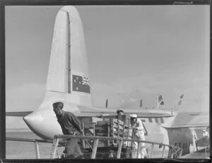 Unloading cargo from flying boat RMA Auckland at Mechanics Bay, Auckland