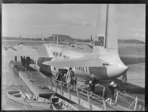Passengers deplaning from the flying boat RMA Auckland at Mechanics Bay, Auckland