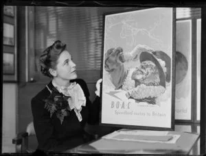 Mary Wootton (Miss New Zealand) holding a BOAC (British Overseas Airways Corporation) poster, at Whites Aviation offices, Auckland
