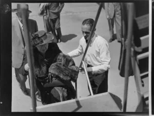 Airline steward F Bennett assisting a passenger into a Dakota aircraft