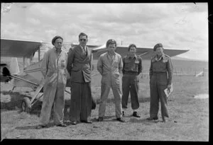 Unidentified group of men standing in front of an Auster aircraft, Waiouru Military Camp