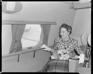 Mary Wootton (Miss New Zealand) inside a Tasman Empire Airways Ltd aeroplane