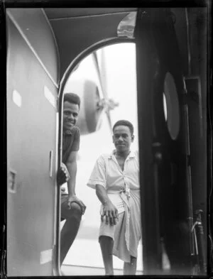 Two Fijian men look in the cabin of the Seaplane Aotearoa in Suva