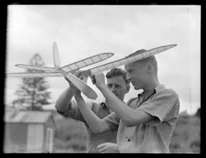 N Hewitson working on his model aeroplane, with L Fellows - Auckland Aero Club