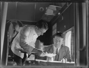 Man being served food in the cabin of the seaplane Aotearoa in Suva