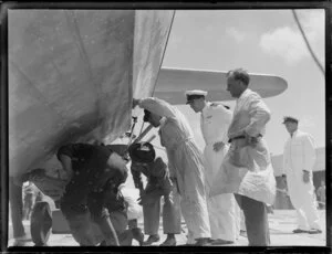 Men inspecting under the ZK-AMA Aotearoa seaplane