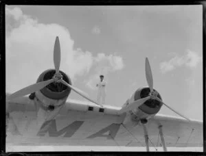 A man standing on the wing of the ZK-AMA Aotearoa seaplane