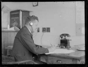 Unidentified man working at a desk, Tasman Empire Airways Ltd, [med section ?]