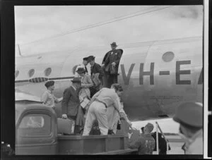 Passengers deplaning onto the tray of a truck
