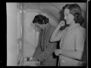 Two women in the washroom of the Constellation aircraft