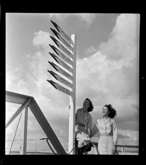 Tasman Empire Airways Ltd signposts and unidentified women