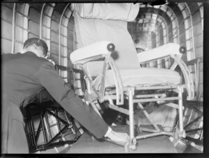 A [steward] fixes a chair, on the seaplane Centaurus, Imperial Airways Ltd