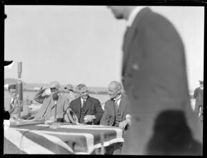 Michael Joseph Savage, with unidentified guests, awaiting the arrival of the seaplane, Centaurus, Imperial Airways Ltd