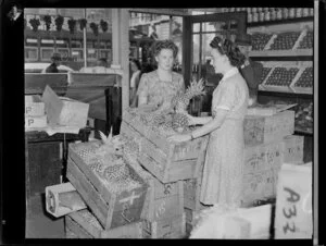 Selling pineapples at Franklins fruit shop, corner of Queen Street, Auckland