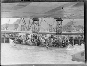 People aboard the boat Owaka, welcoming the seaplane Centaurus to Lyttelton, Christchurch.