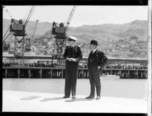 Probably a crew member of the flying boat, Centaurus, talking to an unidentified man, Lyttelton Harbour