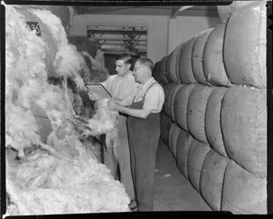 Mr J Marshal and Mr J C Marshal grading wool after it has been baled