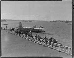 Passengers disembarking Tasman Empire Airways Ltd aircraft, Australia, Mechanics Bay, Auckland