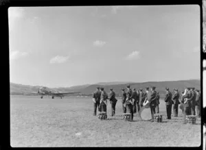 The Otago Air Training Corps band watching a supply dropping Dakota at the Royal New Zealand Aero Club pageant in Dunedin