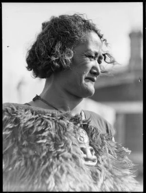 Unidentified Maori woman wearing a feather cloak and hei tiki