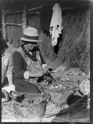 Unidentified Maori woman weaving flax, location unidentified