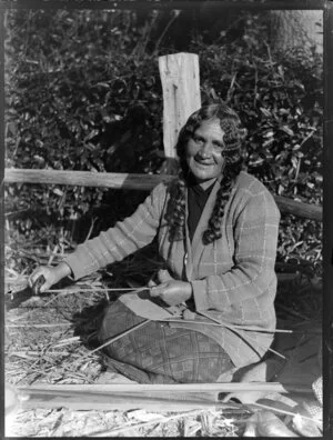 Unidentified Maori woman preparing flax, location unidentified