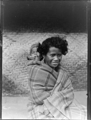 Unidentified Maori child with baby on back wrapped in blanket