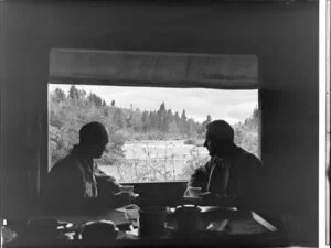 Unidentified men enjoying the scenery of Huka Falls from Huka Lodge, Taupo