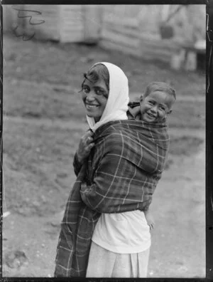 Annie Ngauru Hoko (nee Downs) woman carrying a young child on her back wrapped in a blanket