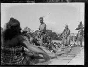 Māori group performing an action song while being filmed, Waikato