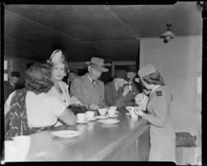Tasman Empire Airlines Ltd, stewardess, Miss L O'Connell, at the refreshement counter, Whenuapai Aerodrome, Auckland