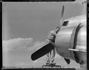 New Zealand National Airways Corporation, engineer at work on a Dakota, Whenuapai Aerodrome, Auckland