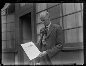 Mr Geo Bolt with certificate of airworthiness for Tasman Empire Airways Ltd