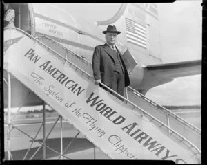 Mr Walter Nash, politician, arriving at [Auckland?] on a Pan American World Airways' Clipper aeroplane