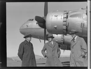 New Zealand National Airways Corporation staff members R Gardiner, left, with Mr Johnson and H Yates, in front of Handley Page Hastings aircraft, Paraparaumu airport, Kapiti Coast District