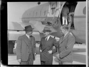 Group from Tasman Empire Airways Limited, including Mr Geoff Roberts, Captain Brownjohn, and an unidentified man, with Handley Page Hastings airplane, location unidentified
