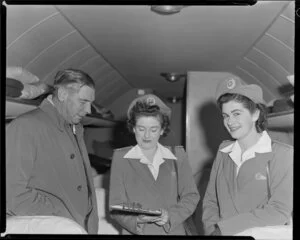 Sir Leonard Isitt, Miss B Lalow, and Miss G Mott inside aeroplane, BCPA [British Commonwealth Pacific Airlines] inauguration, Whenuapai