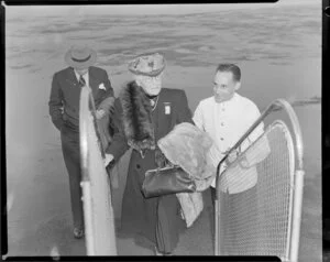 New Zealand National Airways Corporation [NZNAC], assisting elderly passenger on gangway