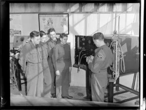 Sergeant B T Topp instructs engine mechanics to AC2 G J Hardon, AC2 L G Croucher, AC2 A F Houlihan and AC2 A Daniels at the propeller governor test bench, Hobsonville Technical Training School
