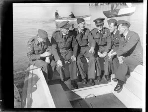 Crew of Catalina flying boat NZ4048 seated in stern of launch. Flight Sergeant V Armstrong, Flight Lieutenant P J Warns, Flight Sergeant C H Harper, Flying Officer E G Leathan, Flying Officer T R Adams, Flight Lieutenant J M Pettigrew, Hobsonville Technical Training School