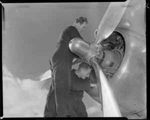 Ground technicians working on an aircraft engine at Whenuapai Aerodrome, Auckland