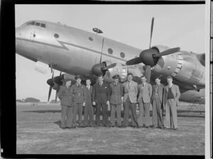 Royal New Zealand Air Force crew, from left, Flight Lieutenant AK Young, Flight Lieutenant E Brewen, Flight Sergeant Green, Squadron Leader HG Hazelden, Flight Lieutenant DG Broomfield, K Lyon, J Rayner, W Thain, and K Bennett, alongside Handley Page Hastings airplane, location unidentified