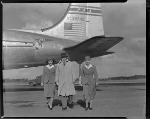 Mr John Wood, Pan American World Airways agent, with Miss Pat Meek and Miss Florence Wood, flight attendants, airplane Clipper Westward Ho in background